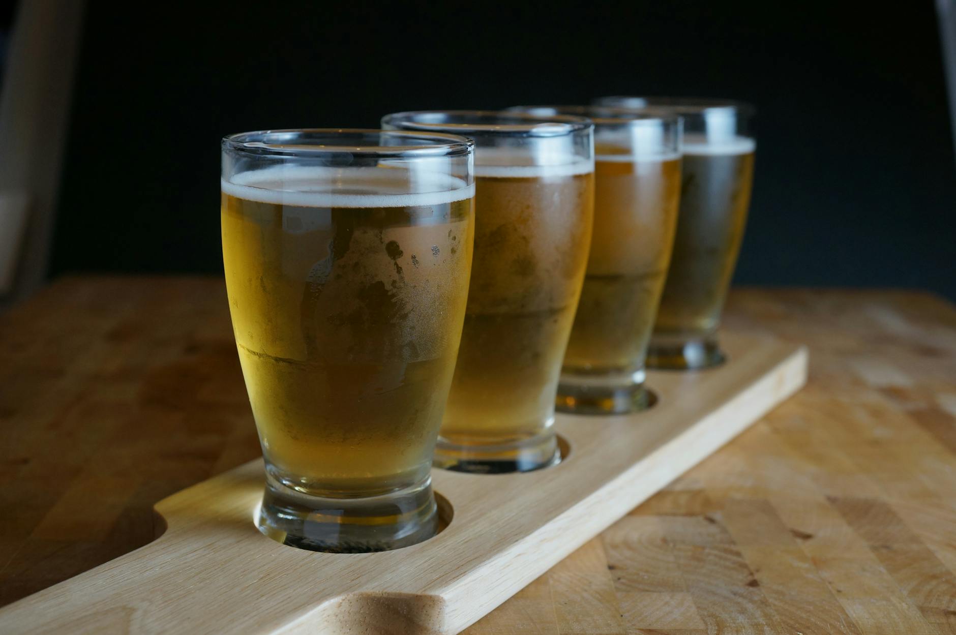 Zestaw degustacyjny piw rzemieślniczych w małych szklankach na desce